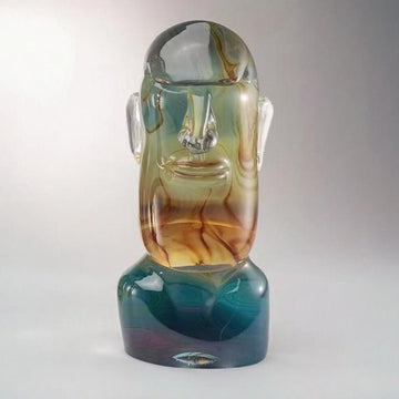 Murano Glass sculpture of a face with a gradient of colors on a white background