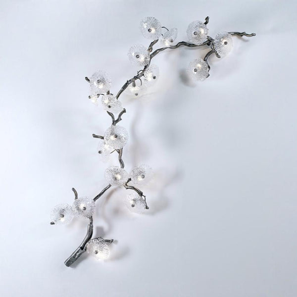 Decorative wall light fixture shaped like a branch with lights on a white background