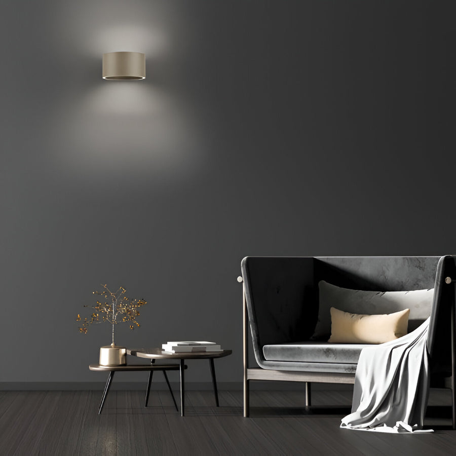 Modern living room with a dark gray wall, a sofa, a coffee table, and a wall-mounted light fixture.
