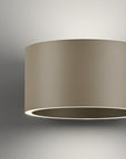 Beige cylindrical light fixture on a gray background