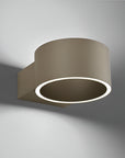 Modern wall-mounted light fixture with a circular design on a gray background