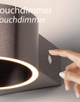 Touchdimmer control being pressed on a modern rechargeable light fixture with 'Touchdimmer' text.