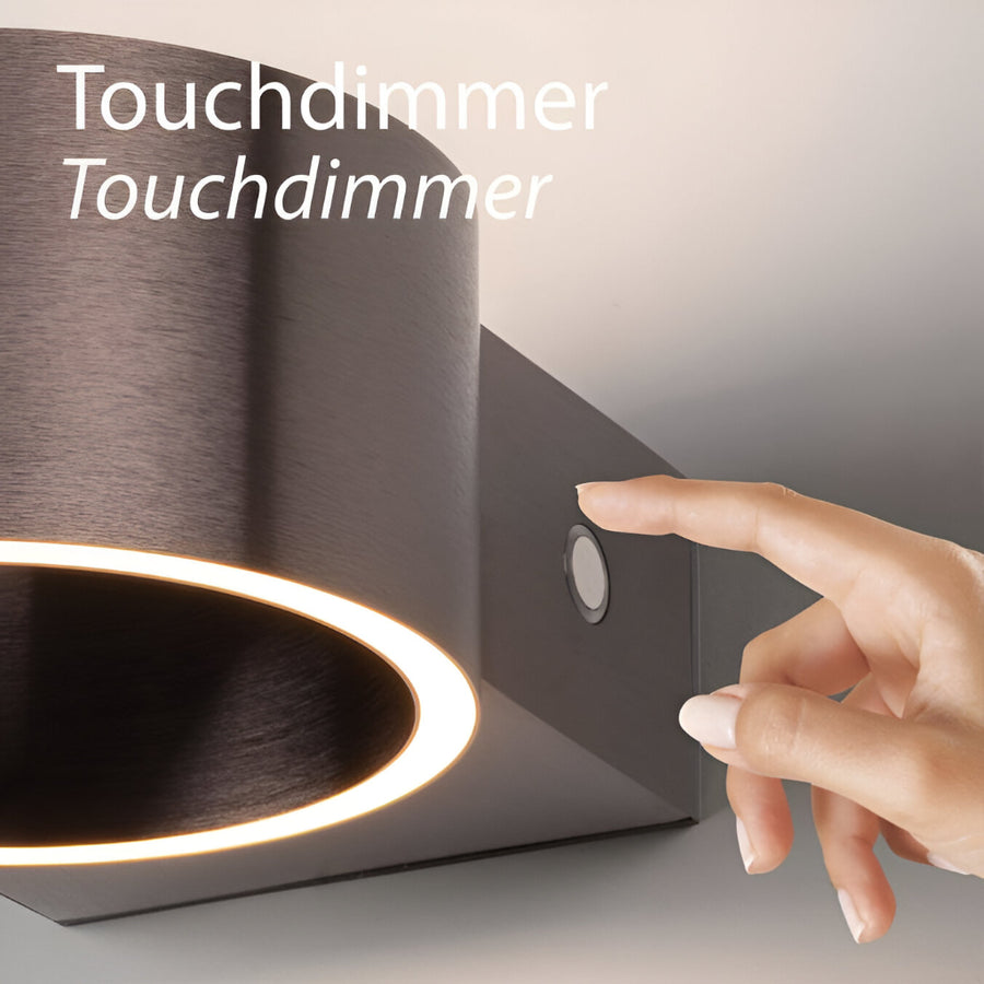 Touchdimmer control being pressed on a modern rechargeable light fixture with 'Touchdimmer' text.
