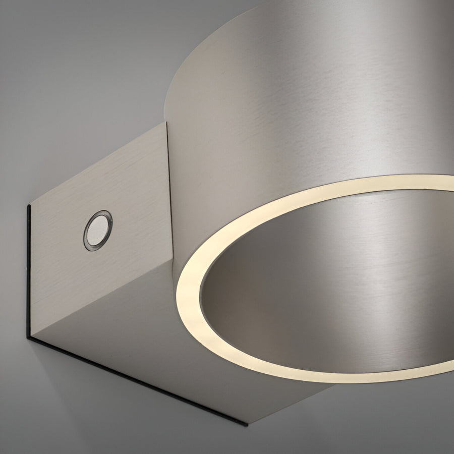 Modern wall-mounted rechargeable light fixture with a metallic finish on a gray background