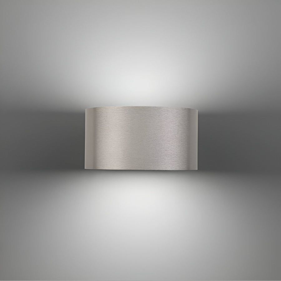 Metallic wall-mounted rechargeable light fixture on a gray background