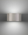 Metallic wall-mounted light fixture on a gray background