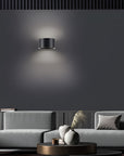 Modern living room with a gray sofa, coffee table, and wall-mounted rechargeable light fixture.