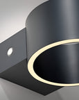 Black wall-mounted rechargeable light fixture with gold accent on a gray background