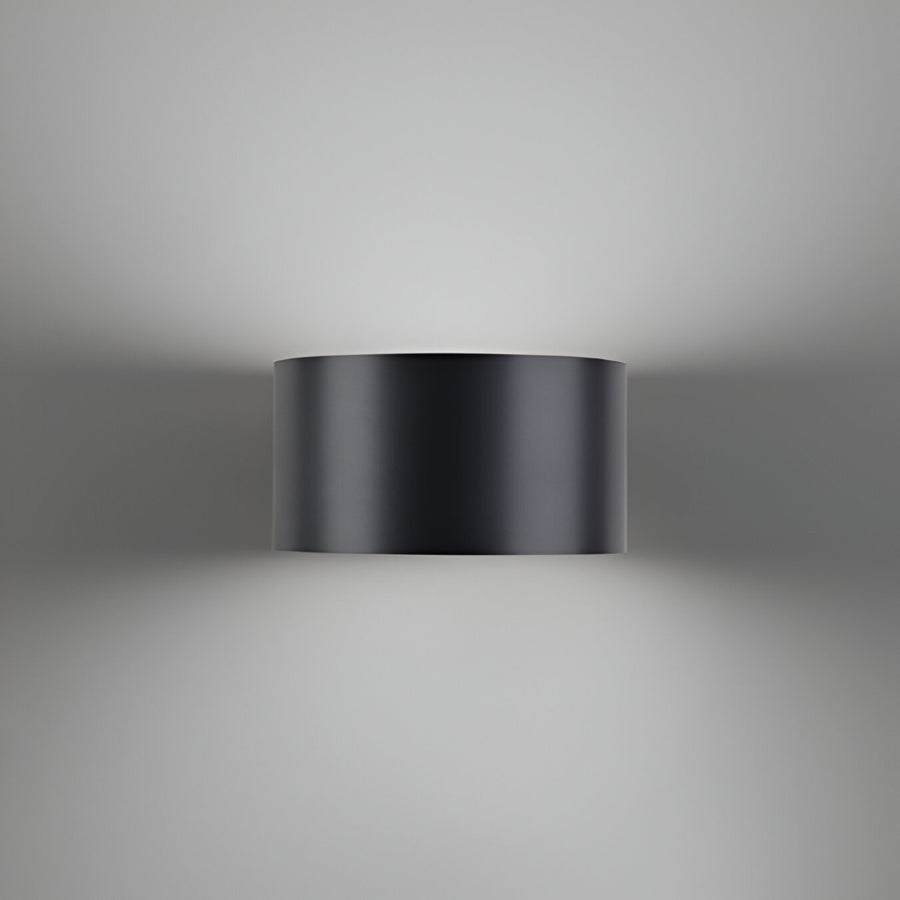 Black cylindrical wall rechargeable light fixture on a gray background
