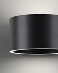Black cylindrical light fixture on a gray background