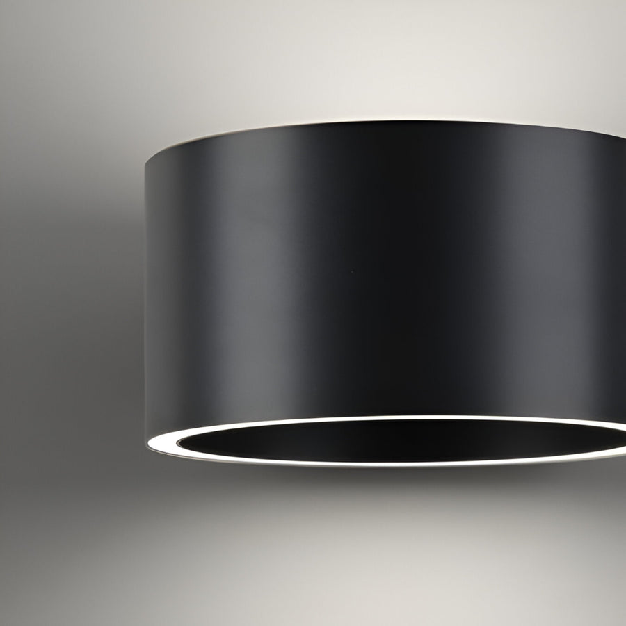 Black cylindrical light fixture on a gray background
