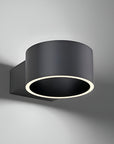 Black cylindrical wall light fixture on a gray background