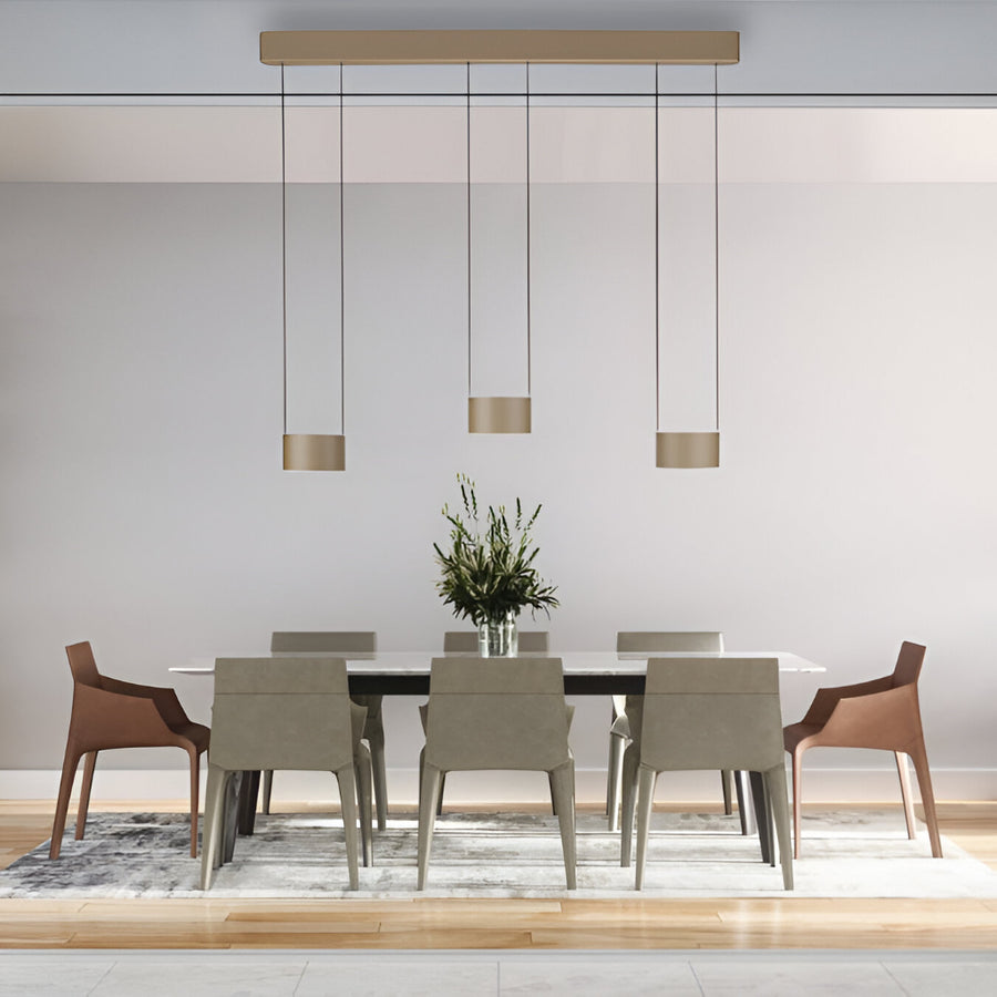 Modern dining room with a table and chairs under pendant lights.