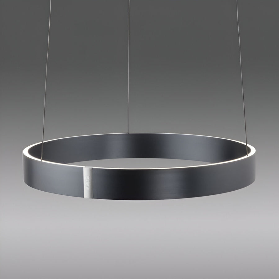 Modern pendant light with a dark gray circular shade on a gray background