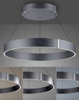Modern pendant kinetic light with circular design on a gray background showing different colour temperatures. 