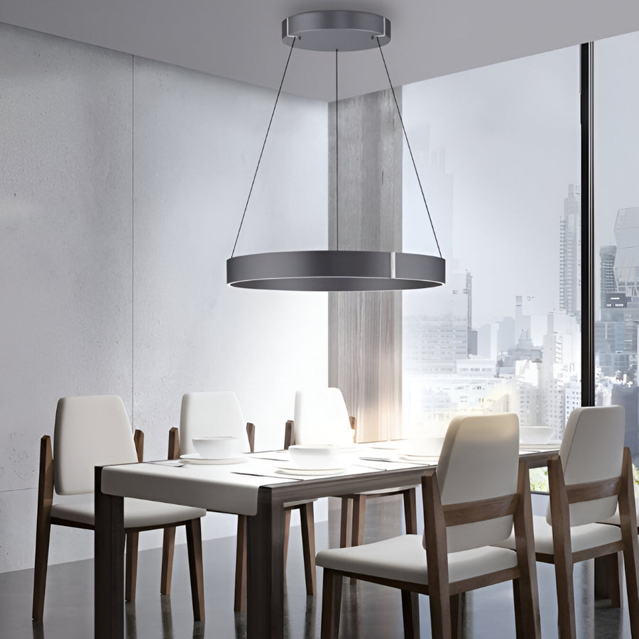 Modern dining room with a kinetic chandelier, table, and chairs.