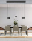 Modern dining room with a table and chairs under height adjustable chandeliers. 