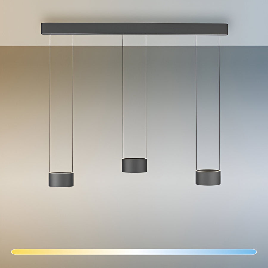 Modern pendant light fixture with three hanging cylindrical shades against a gradient background