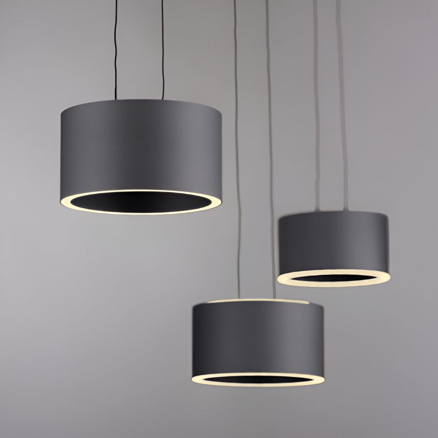 Three black pendant lights against a gray background