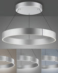 Modern kinetic chandelier with circular design on a gray background