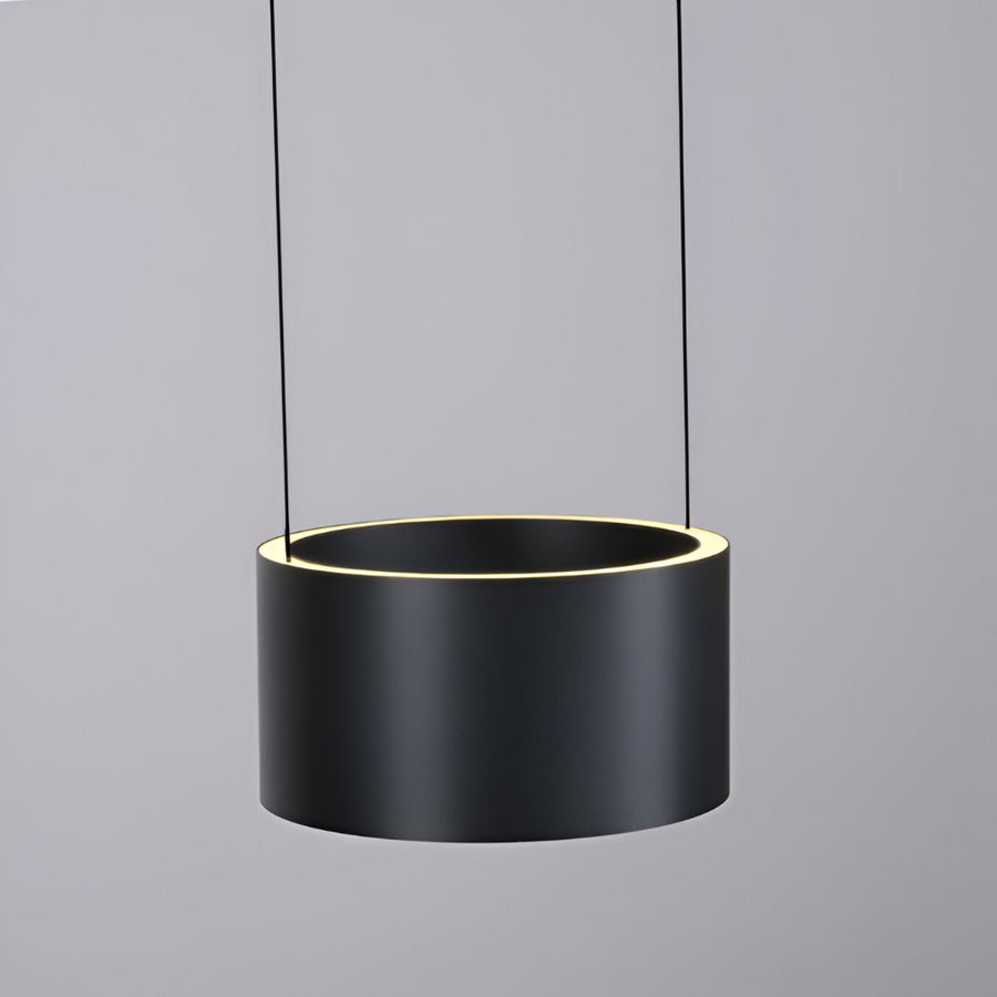 Black cylindrical pendant light with a gray background