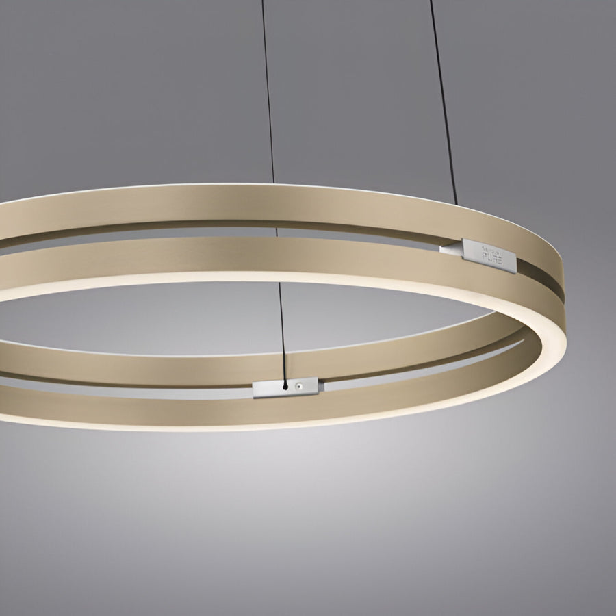 Modern kinetic chandelier with three circular rings on a gray background