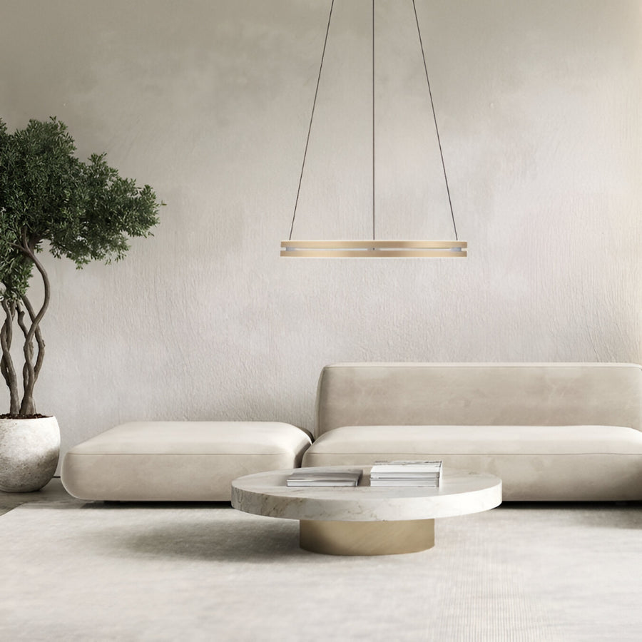 Modern living room with a beige sofa, round coffee table, and hanging kinetic light fixture available at Spacio retail store in Mumbai. 