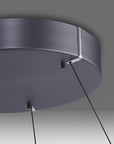 Kinetic ceiling light fixture with dark gray finish on a neutral background