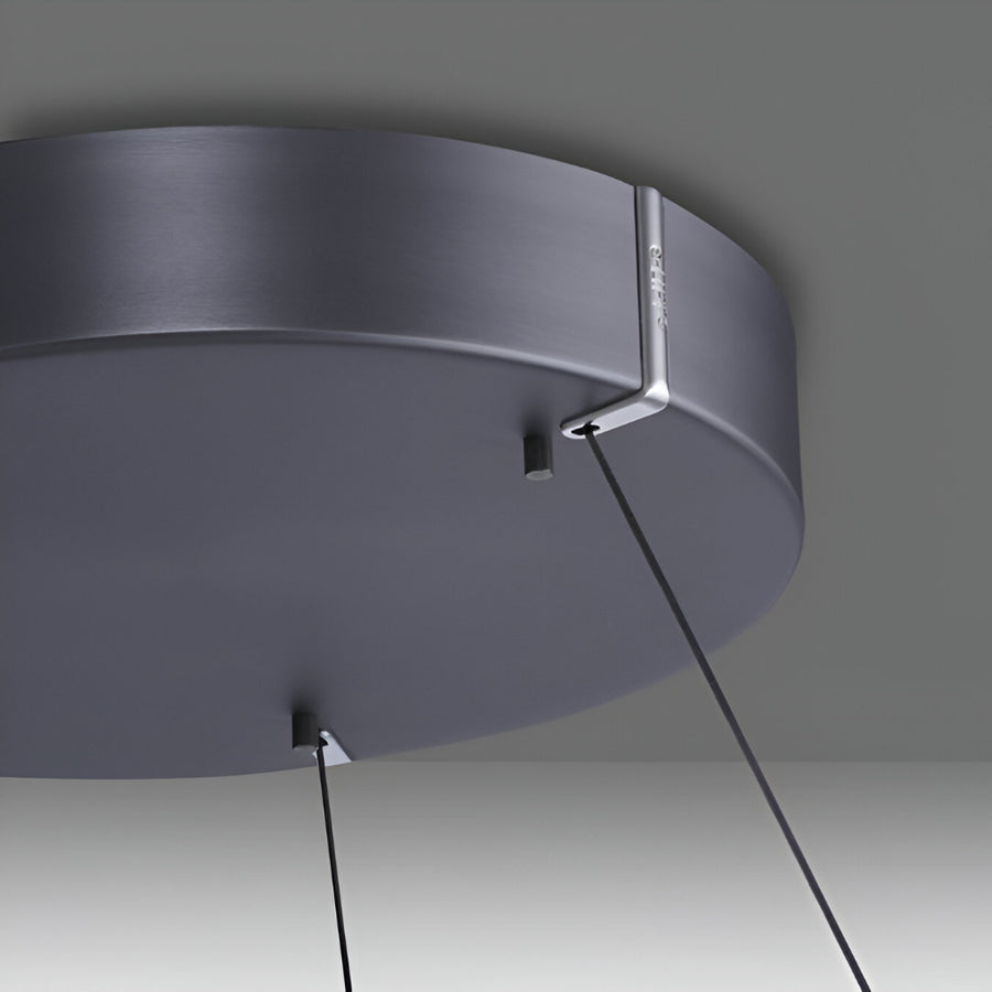 Kinetic ceiling light fixture with dark gray finish on a neutral background