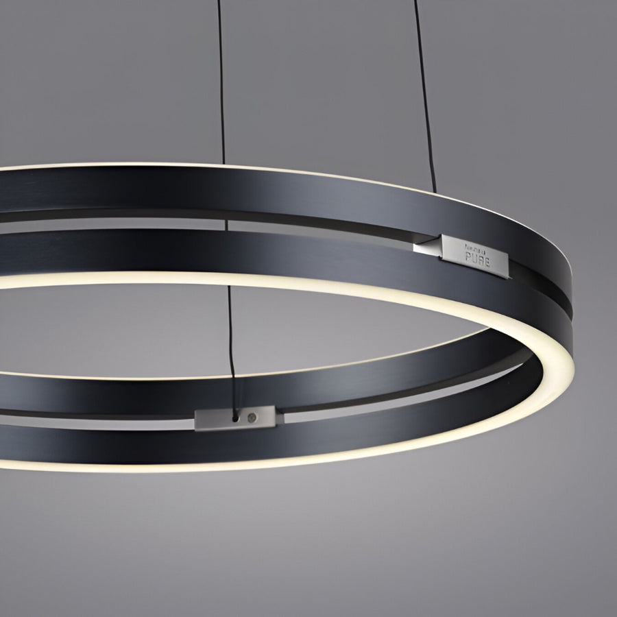 Modern black kinetic chandelier with circular design on a gray background