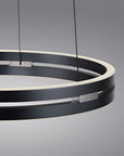 Modern black circular kinetic pendant light on a gray background