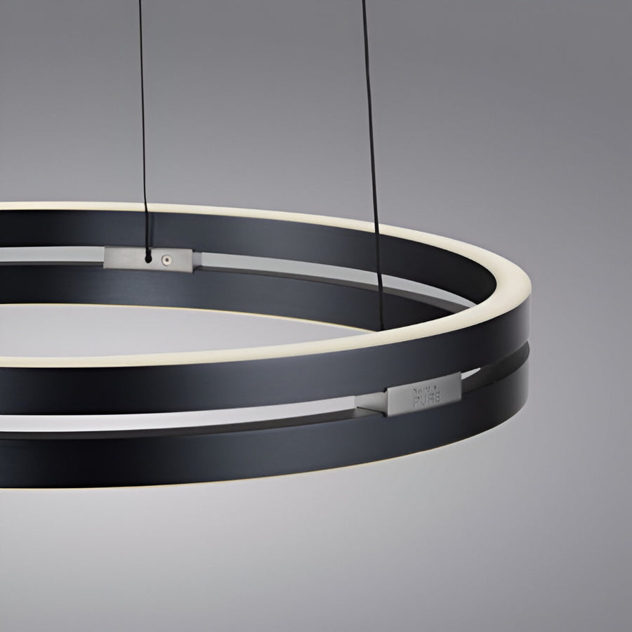 Modern black circular kinetic pendant light on a gray background