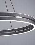 Modern pendant kinetic light with circular design on a gray background