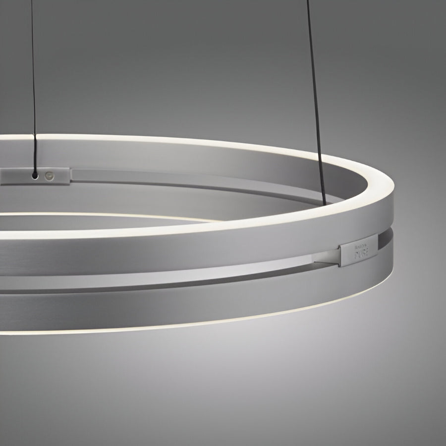 Modern pendant kinetic light with circular design on a gray background