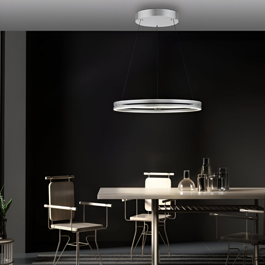 Modern dining room with a kinetic pendant light fixture against a black wall.