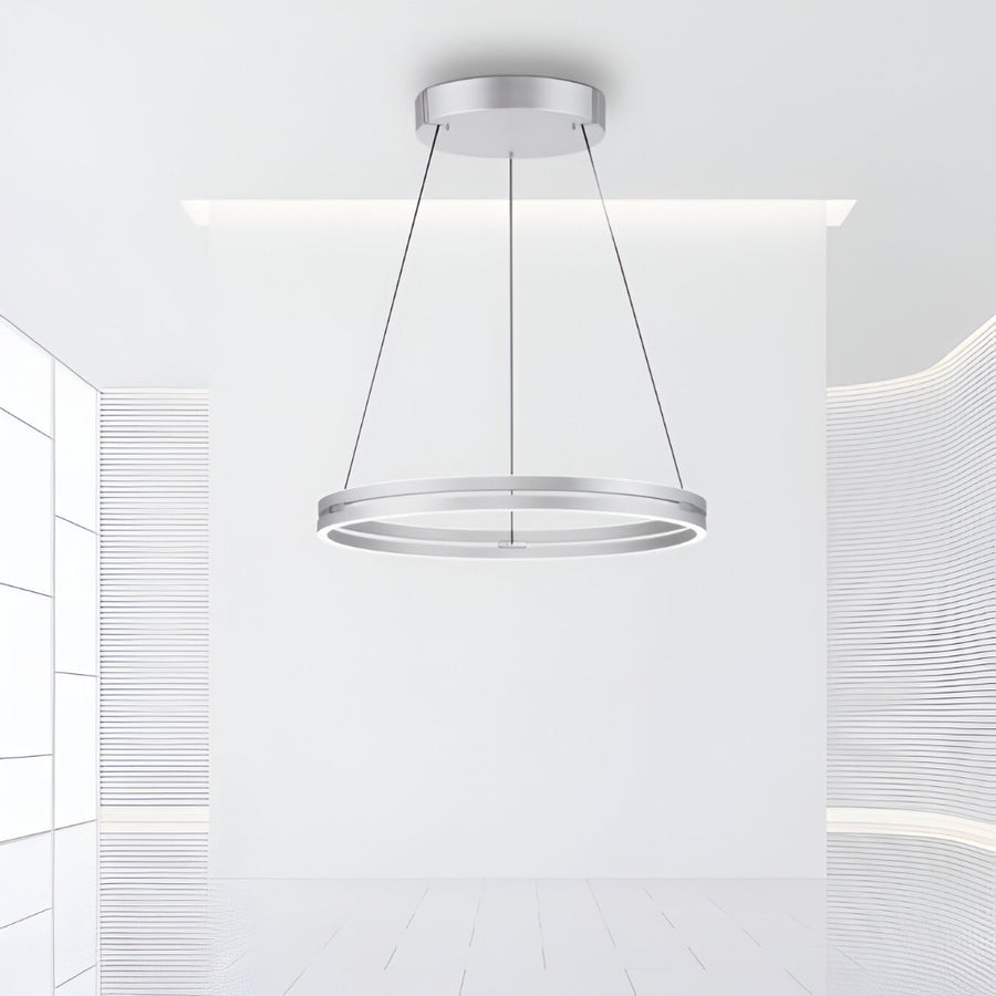 Modern pendant kinetic light fixture hanging from the ceiling in a minimalistic interior.