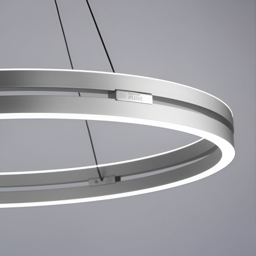 Circular pendant kinetic light fixture on a gray background