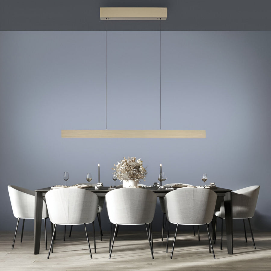 Modern dining room with a long table and chairs, featuring suspension pendant kinetic lights against a gray wall from Neuhaus Pure, available at Spacio retail store in Mumbai & Kolkata. 