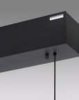Close up of Modern black pendant kinetic light fixture on a gray background