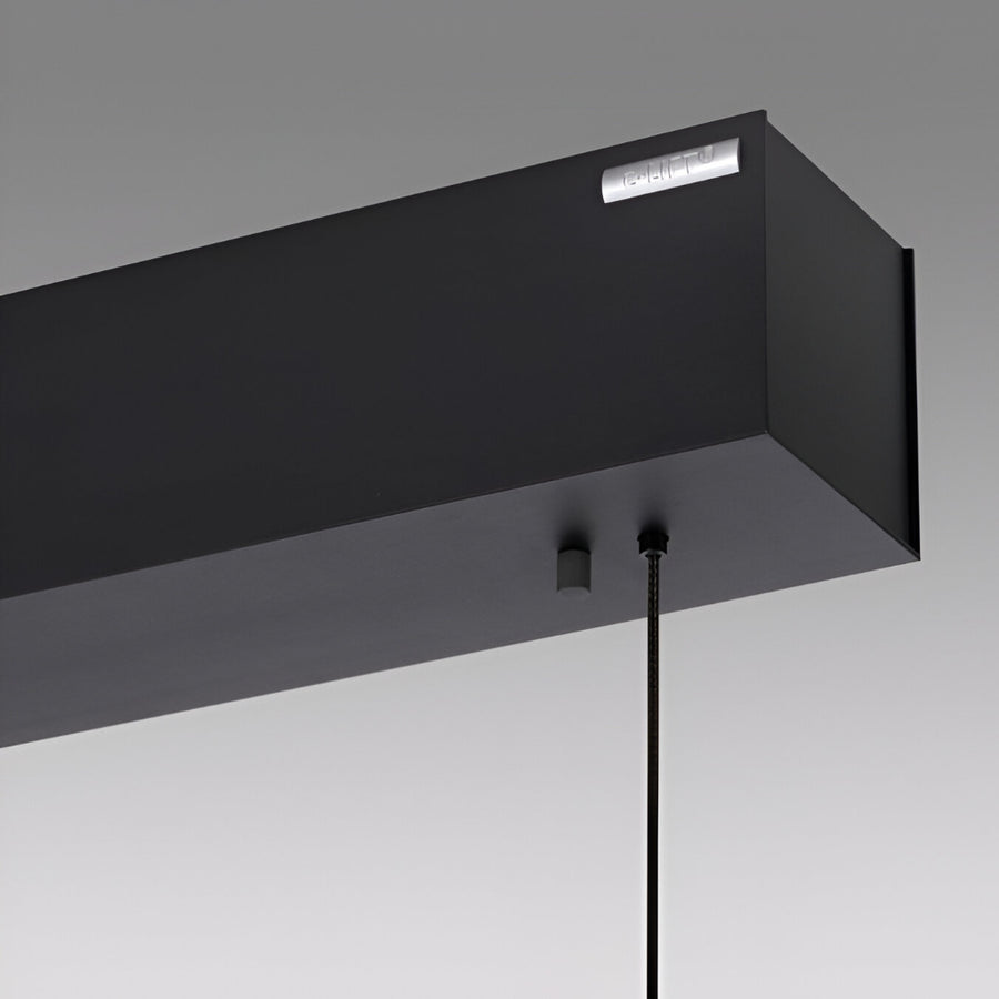 Close up of Modern black pendant kinetic light fixture on a gray background