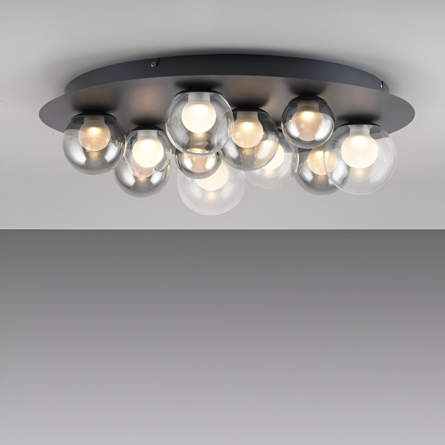 Ceiling light fixture with multiple glass bulbs on a plain background