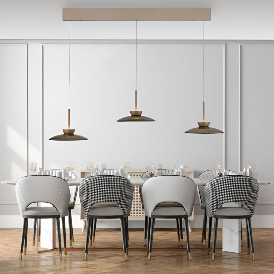 Modern dining room with white walls, wooden floor, and pendant lights with manual comfort lift system for adjustable height. 
