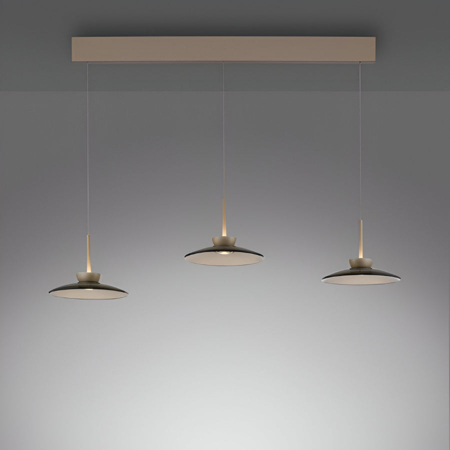 Modern pendant light fixture with three hanging lamps on a gray background with adjustable height system from Neuhaus Pure, available at Spacio in India. 