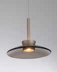 Modern pendant light with a metallic finish on a gray background