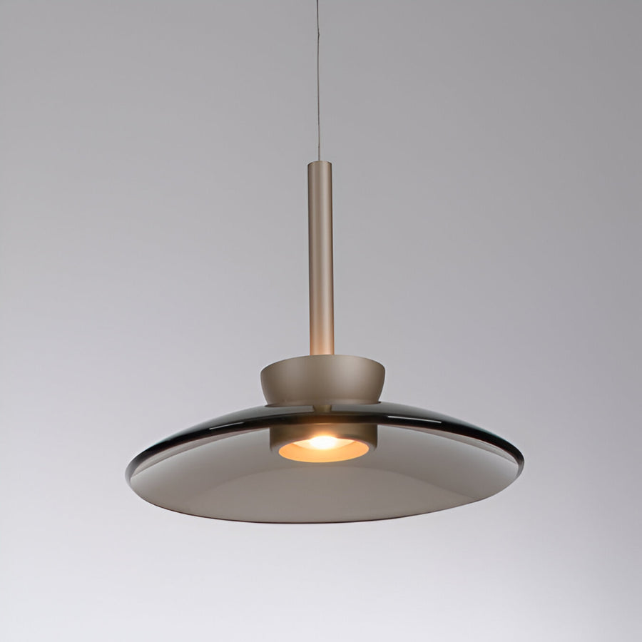 Modern pendant light with a metallic finish on a gray background