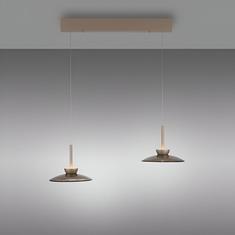 Two pendant lights hanging from a rectangular light fixture against a gradient gray background.