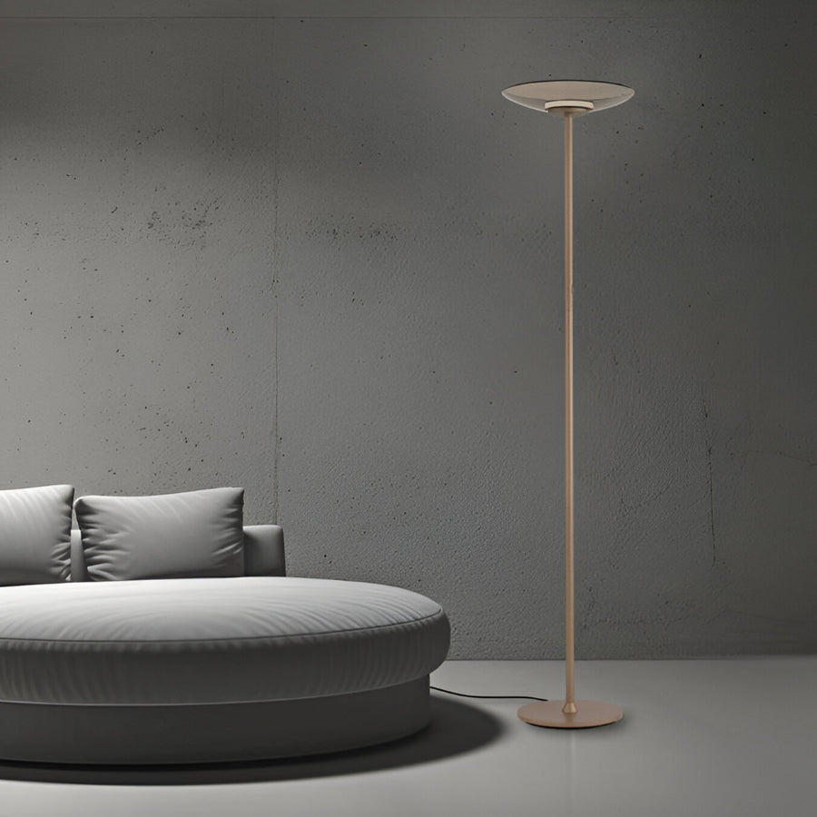 Modern floor lamp next to a gray sofa against a gray wall