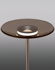 Modern floor lamp with glass top and metal base on a gray background