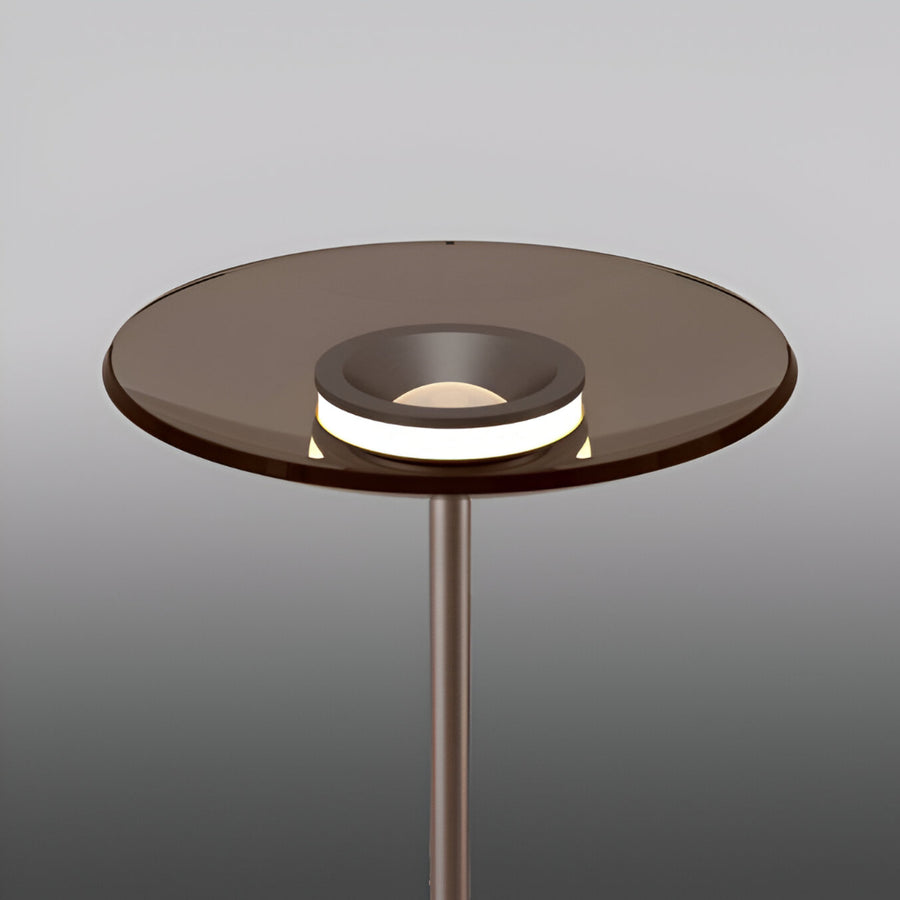 Modern floor lamp with glass top and metal base on a gray background