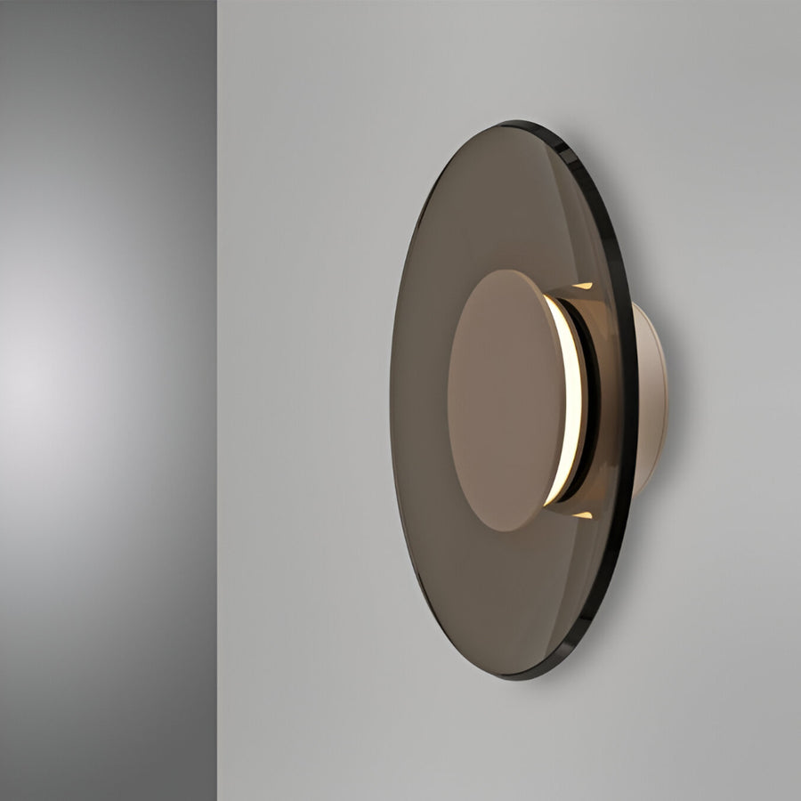 Modern wall light fixture with smoked glass cover on a gray background
